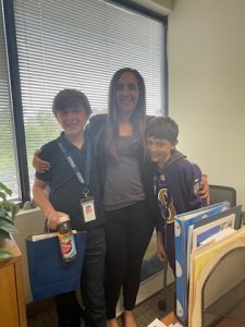 An office employee smiling with two children