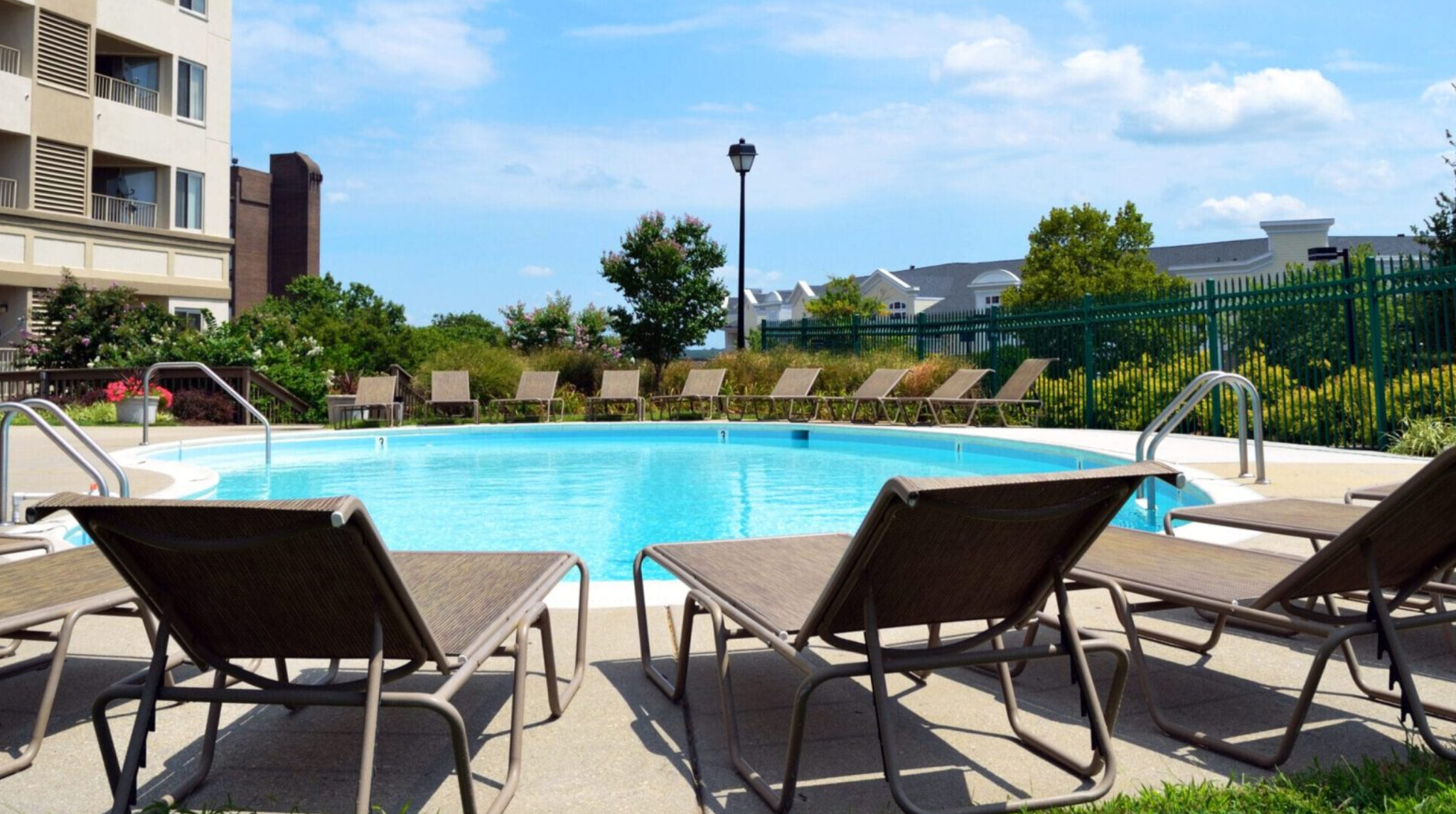 A pool with lounge chairs surrounding it